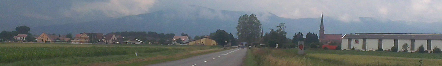 Banner showing distant mountains under low cloud