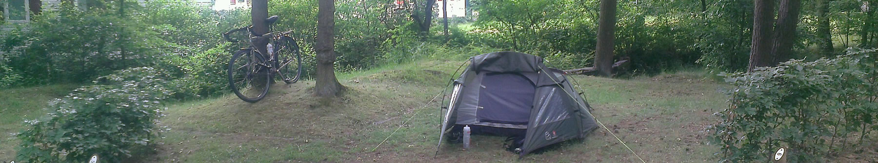 Banner showing tent and bike on wooded camping pitch