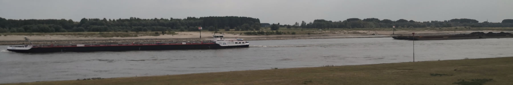 Banner showing long barge chugging down waterway